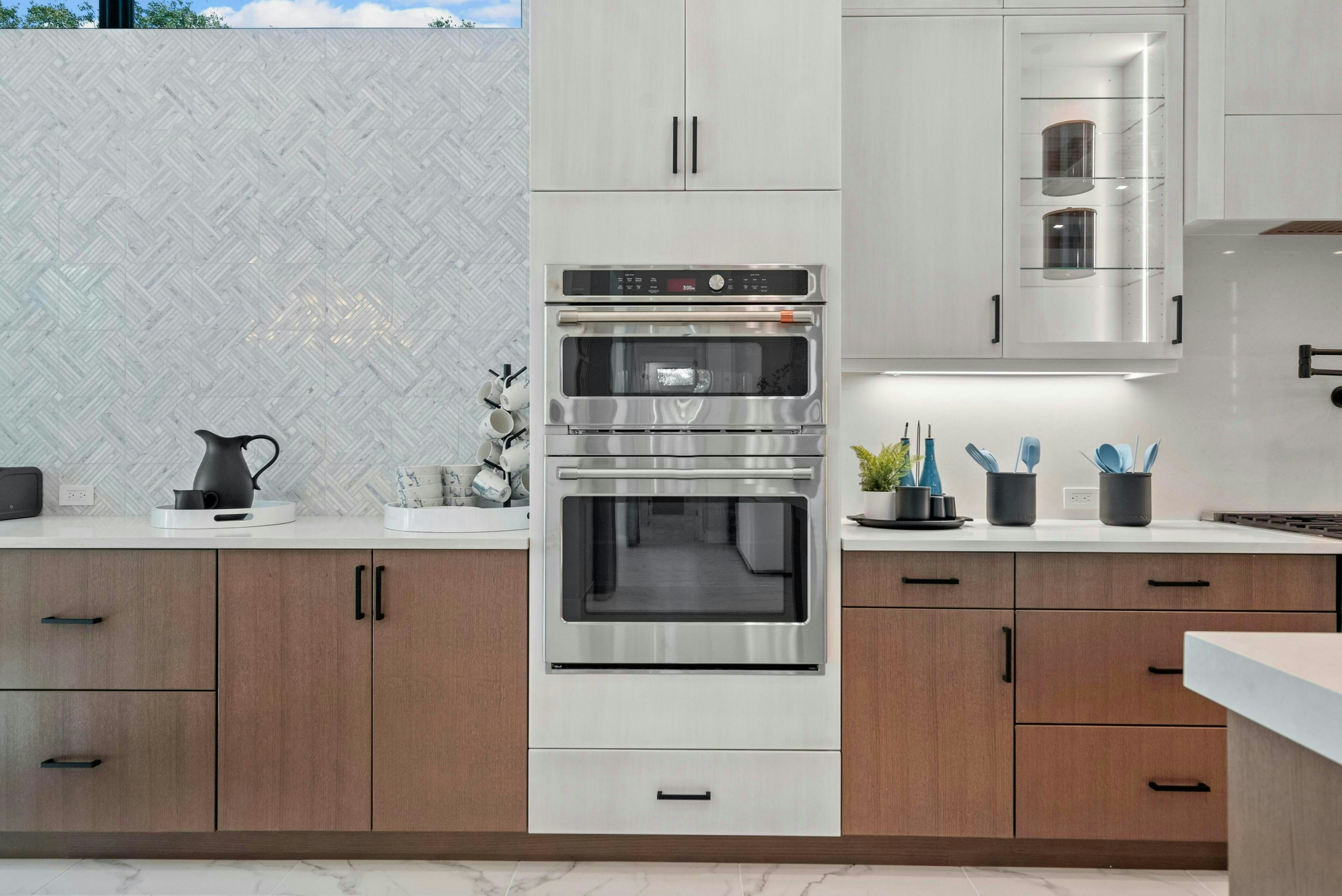 Wall oven and micro combo tower with brown lower cabinets and white above