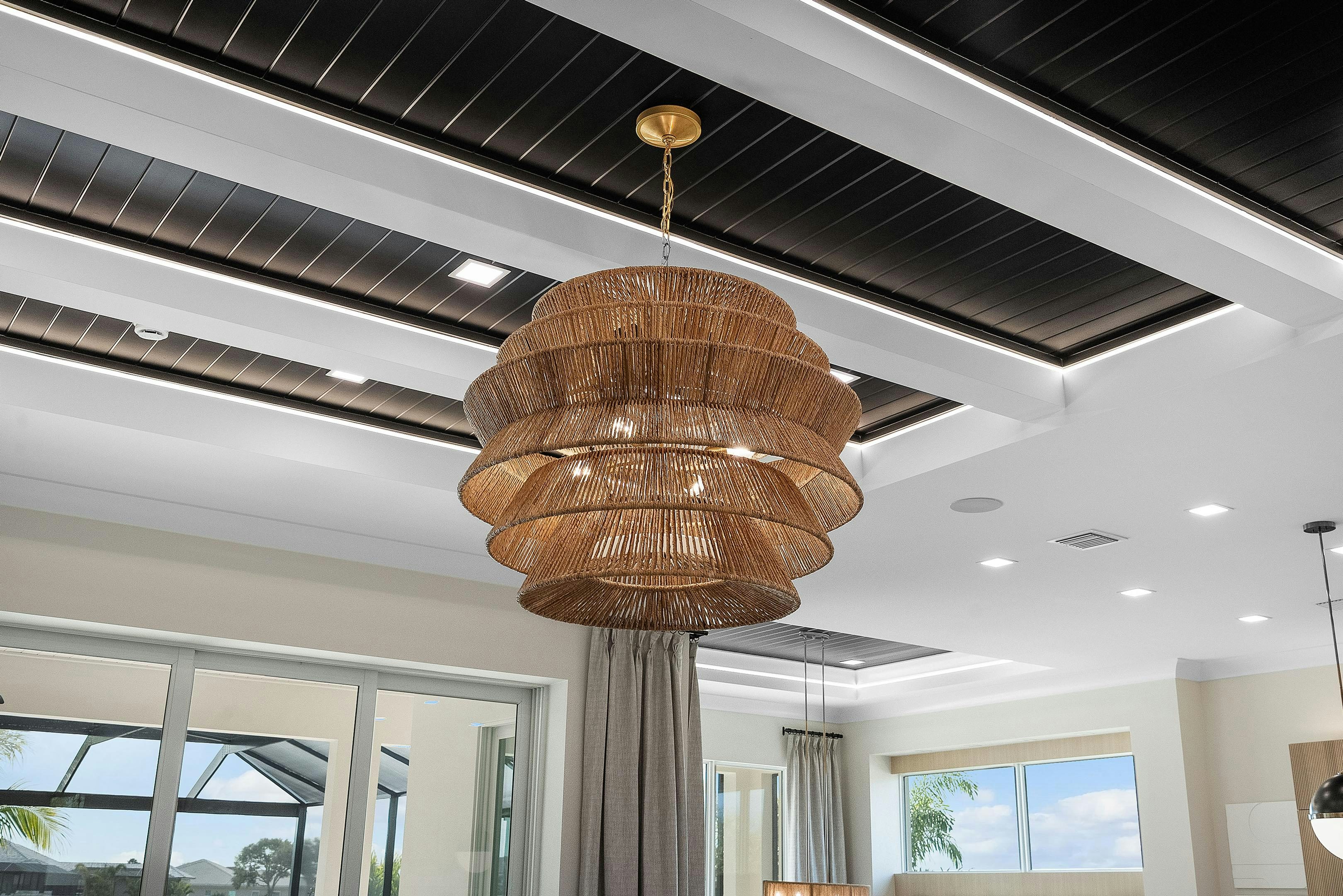 Box Beam ceiling with black inset and a wicker chandelier