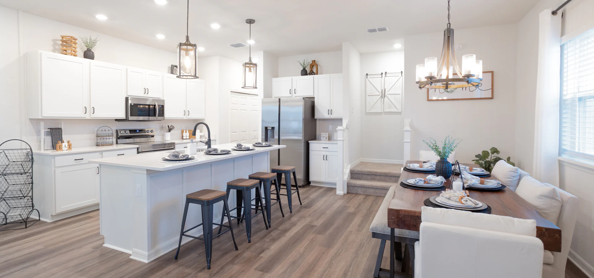 Modern farmhouse style decor with rustic wood flooring and light fixtures