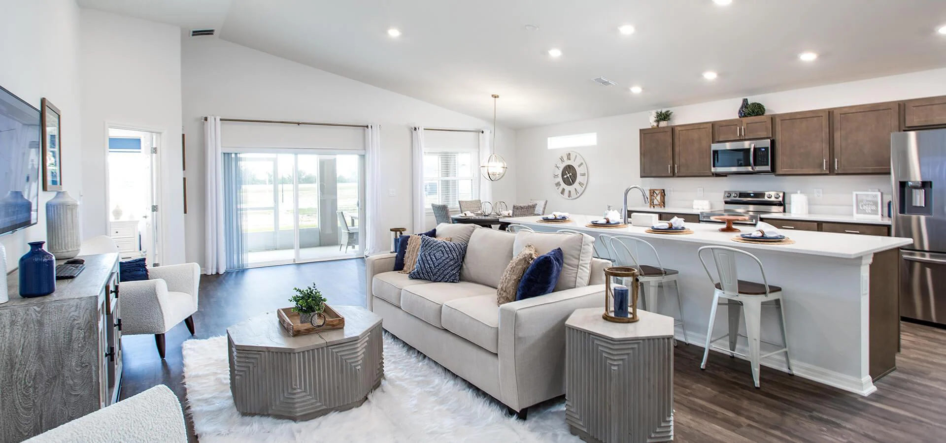 Open living area with light neutral colors and metallic accents