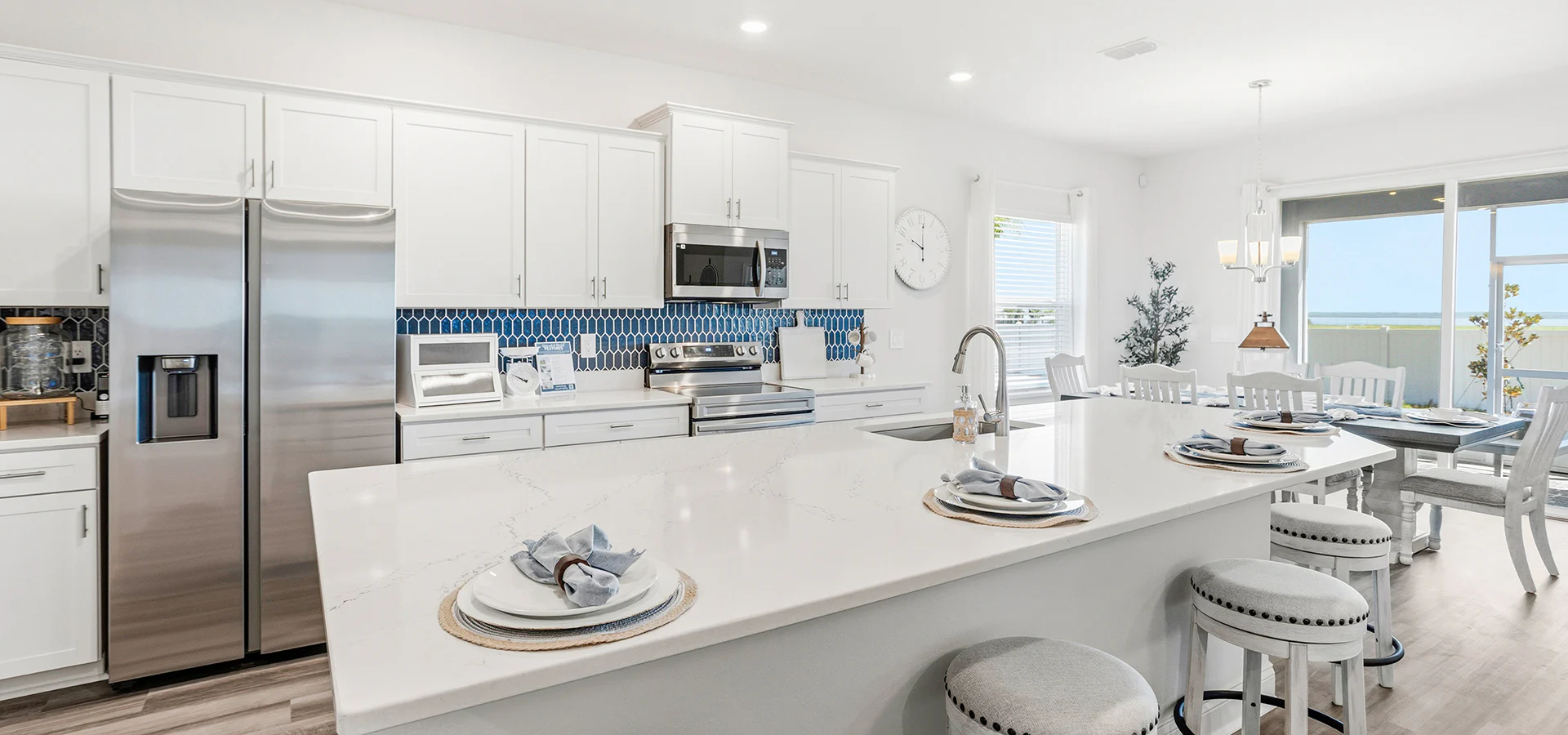 Kitchen in the Shelby II by Highland Homes decorated in white and blue tones