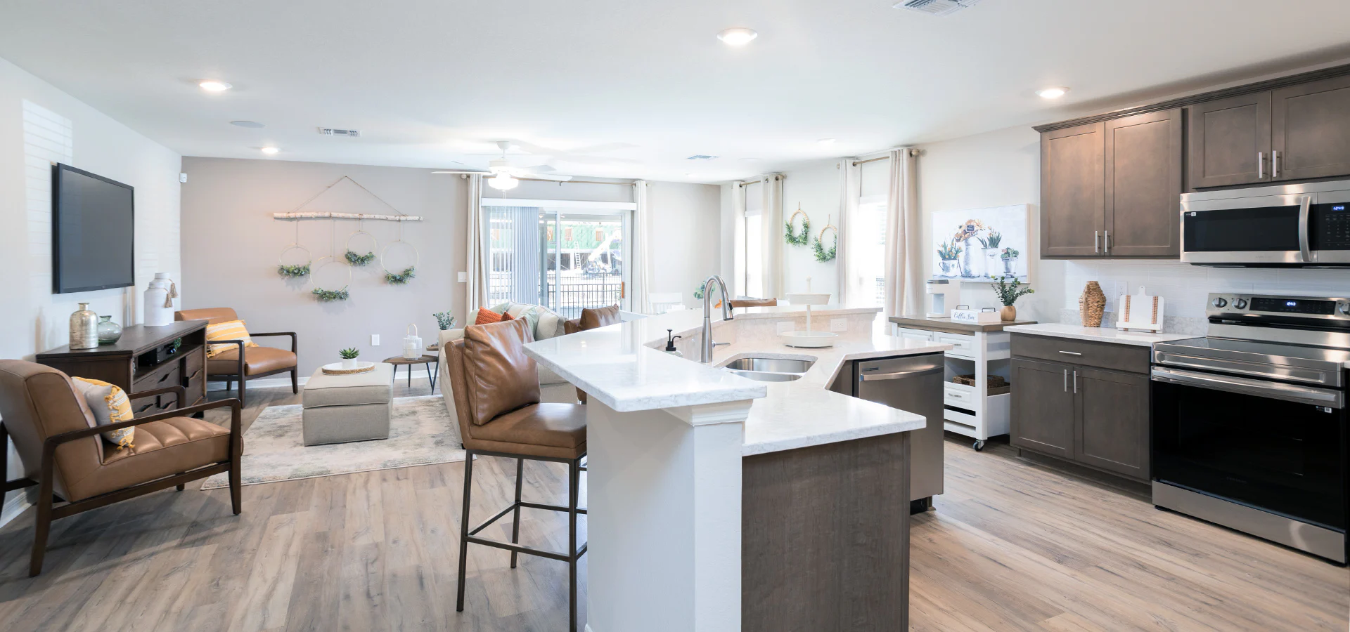 Open kitchen and living area with warm natural woods and leather furntiure