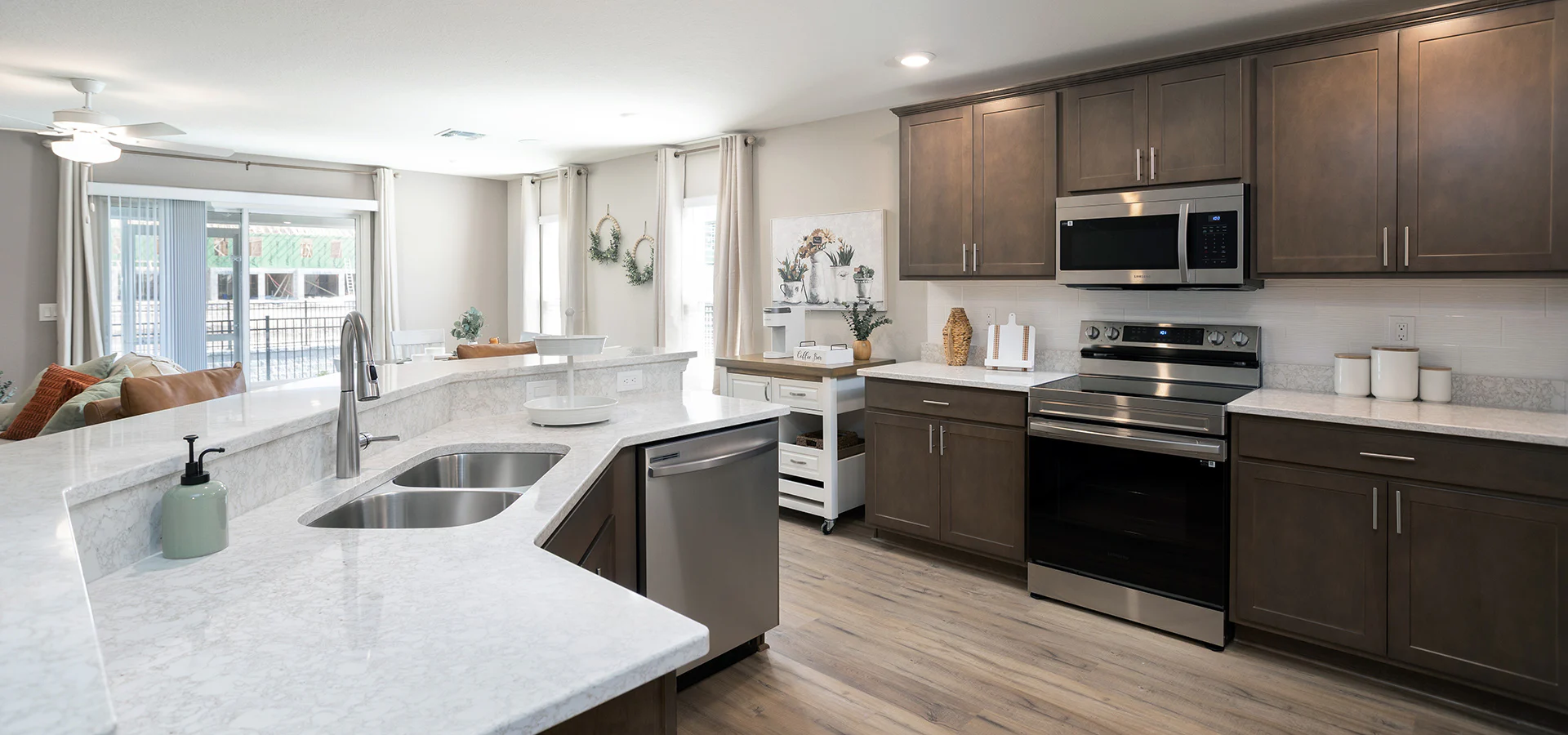 Open kitchen with wood cabinets and quartz counters