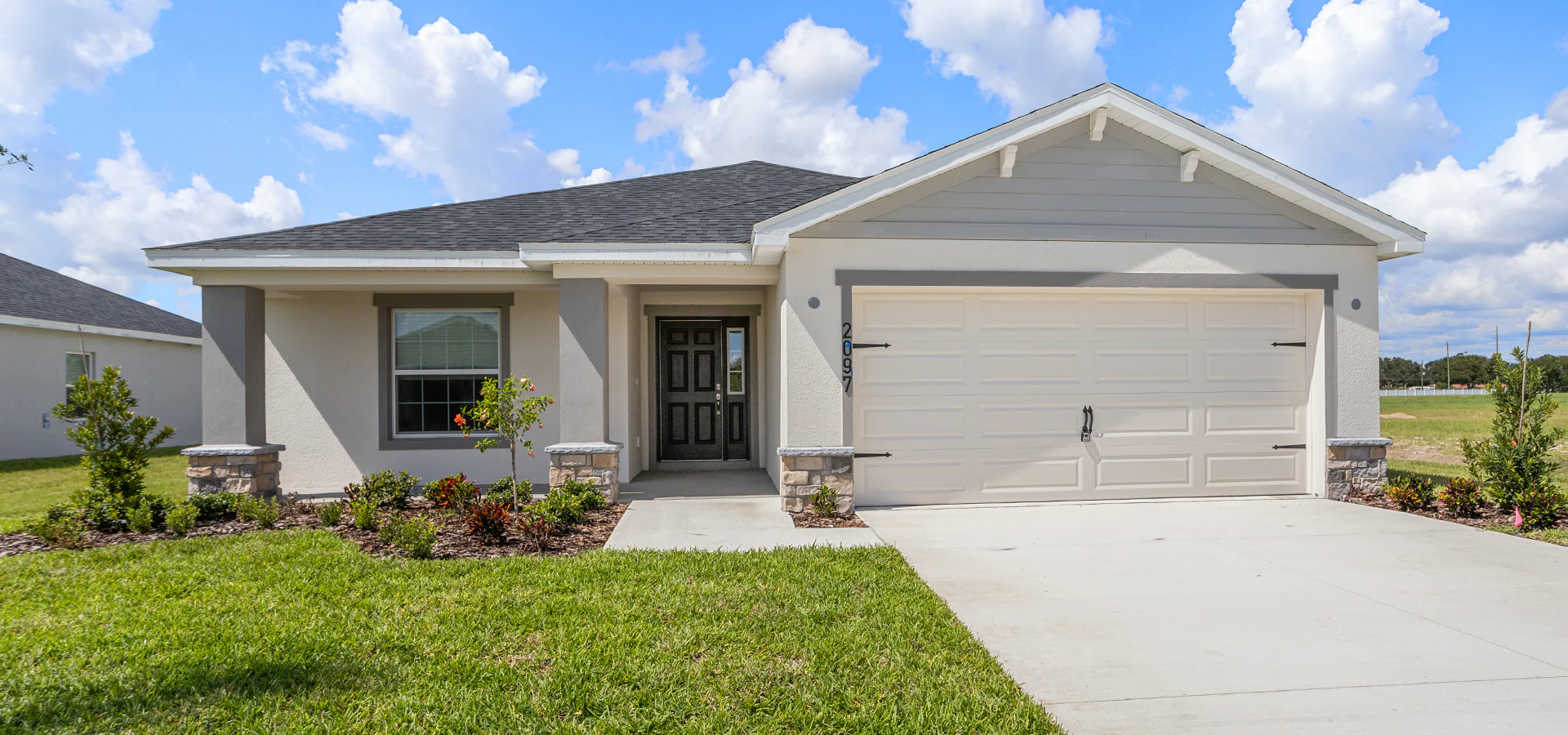 The Raychel by Highland Homes includes Craftsman style siding and stone exterior details