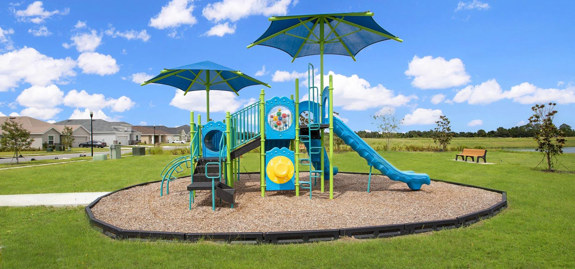 Siena Reserve community playground with shade umbrellas