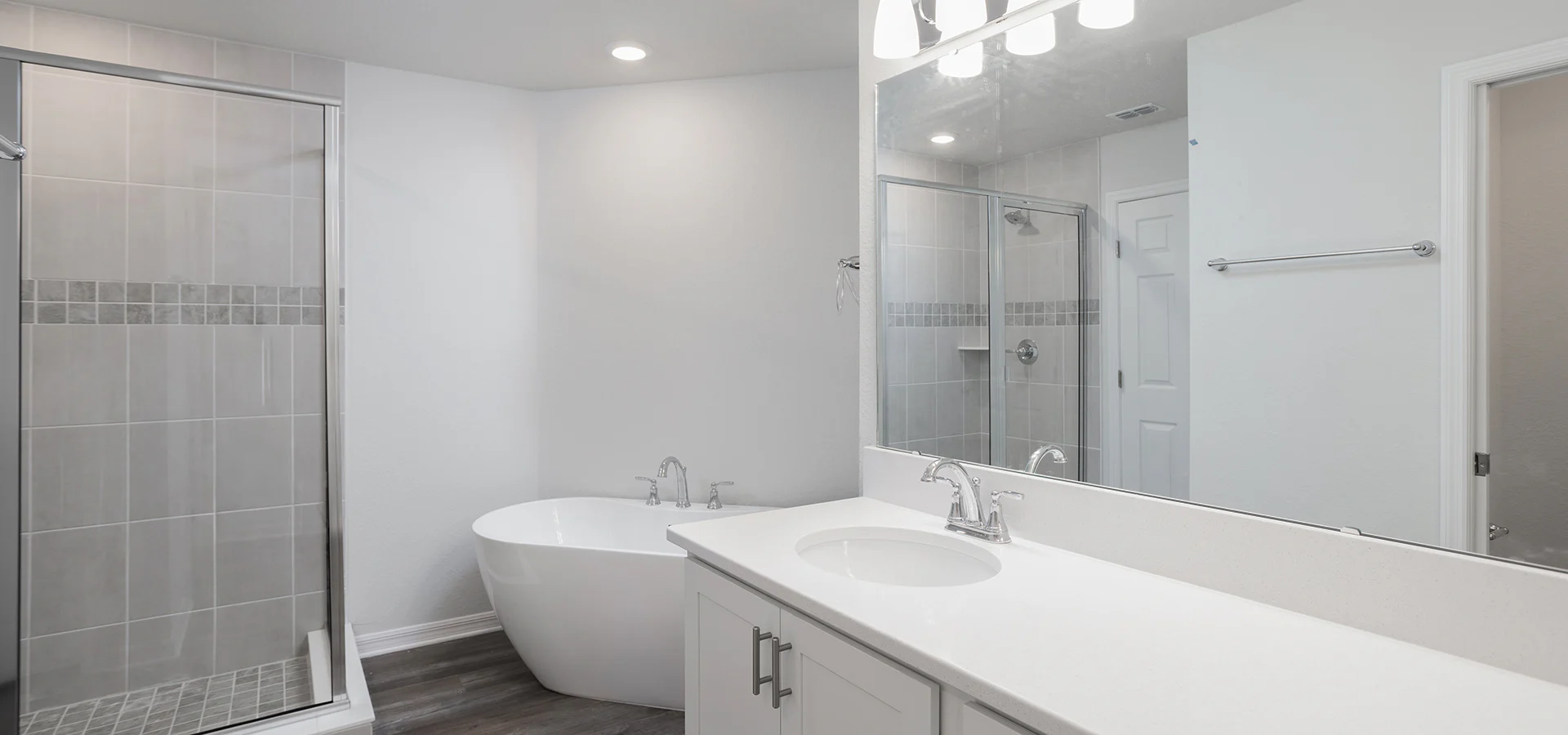 Spacious en-suite bathroom with a freestanding tub and tiles shower, in a Saint Cloud, Florida new home