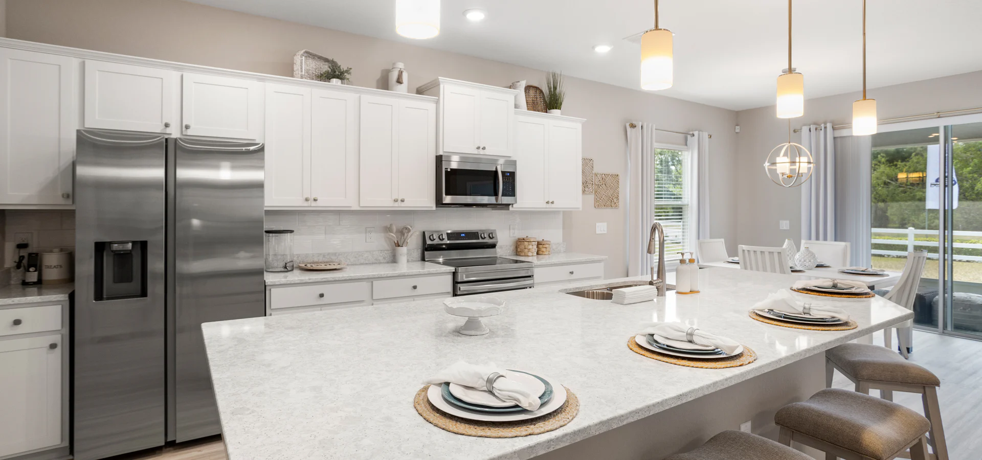 Bright, open kitchen with quartz and white cabinets in a Lake Alfred new construction home